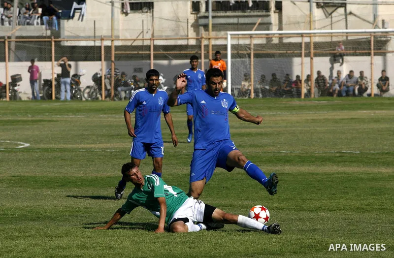 Players from Rafah Youth Club play against the players from Rafah Services Club during a football match in the League Cup of the Gaza Strip at Rafah Municipality Stadium in the southern Gaza Strip on May 30, 2012. Photo...