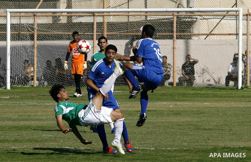 Players from Rafah Youth Club play against the players from Rafah Services Club during a football match in the League Cup of the Gaza Strip at Rafah Municipality Stadium in the southern Gaza Strip on May 30, 2012. Photo...