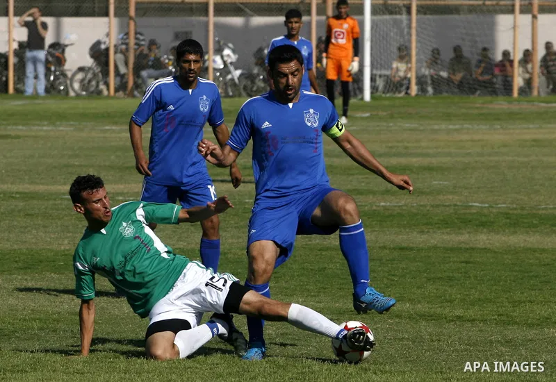 Players from Rafah Youth Club play against the players from Rafah Services Club during a football match in the League Cup of the Gaza Strip at Rafah Municipality Stadium in the southern Gaza Strip on May 30, 2012. Photo...