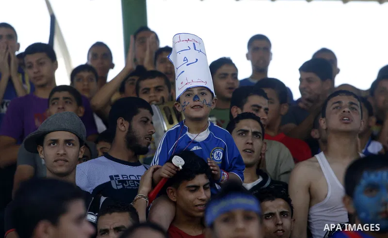 Players from Rafah Youth Club play against the players from Rafah Services Club during a football match in the League Cup of the Gaza Strip at Rafah Municipality Stadium in the southern Gaza Strip on May 30, 2012. Photo...