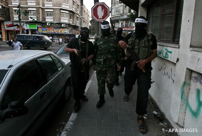 Masked Palestinian militants of a group affiliated with the Al Mujahideen Brigades attend a press conference in Gaza City, on May. 30, 2012. Photo by Ali Jadallah