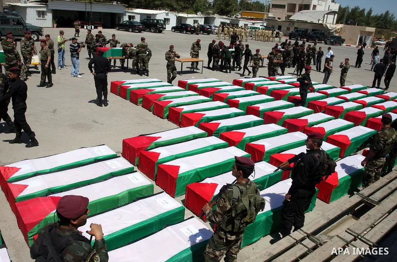 Palestinian security forces carry flag-draped coffins during preparations for the funeral procession of 91 Palestinians whose remains were returned by Israel in the West Bank city of Ramallah on May 31, 2012. Israel hand...