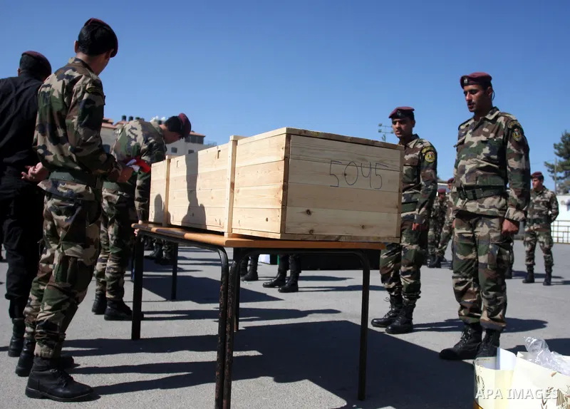 Palestinian security forces carry flag-draped coffins during preparations for the funeral procession of 91 Palestinians whose remains were returned by Israel in the West Bank city of Ramallah on May 31, 2012. Israel hand...