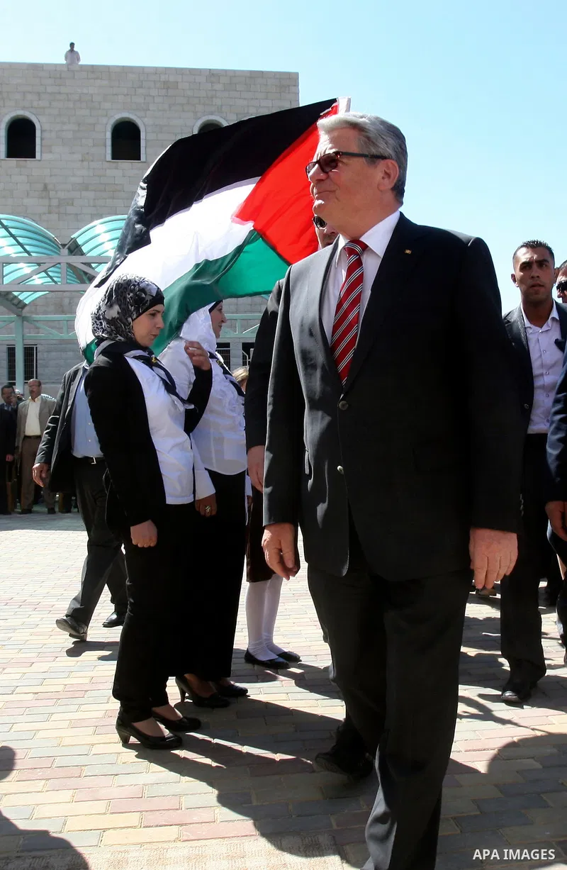 German President Joachim Gauck is greeted by Palestinian girls upon his arrival to the West Bank village of Burin, south of Nablus, to attend the inauguration of a German-funded girls' school on May 31, 2012. Photo by Wa...