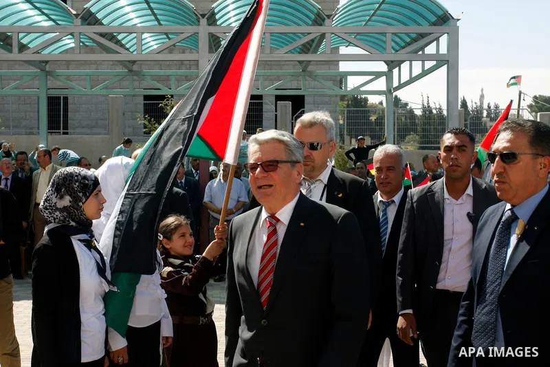 German President Joachim Gauck is greeted by Palestinian girls upon his arrival to the West Bank village of Burin, south of Nablus, to attend the inauguration of a German-funded girls' school on May 31, 2012. Photo by Wa...