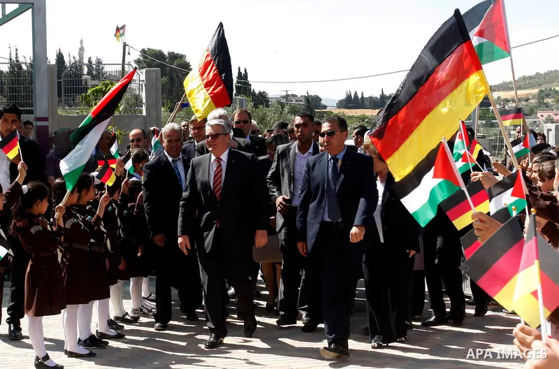 German President Joachim Gauck is greeted by Palestinian girls upon his arrival to the West Bank village of Burin, south of Nablus, to attend the inauguration of a German-funded girls' school on May 31, 2012. Photo by Wa...