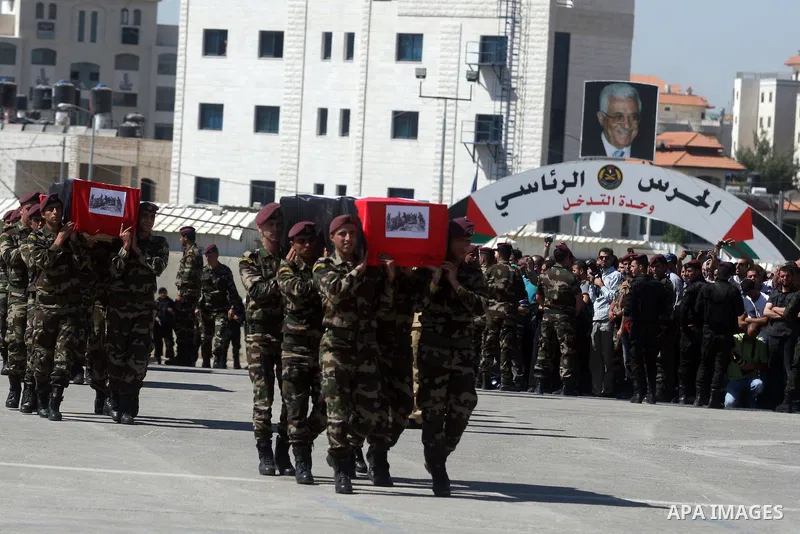 Palestinian Presidential guards carry flag-drapped coffins containing the remains of Palestinian militants during an official ceremony at the President's headquarter in the West Bank town of Ramallah, 31 May 2012. Israel...