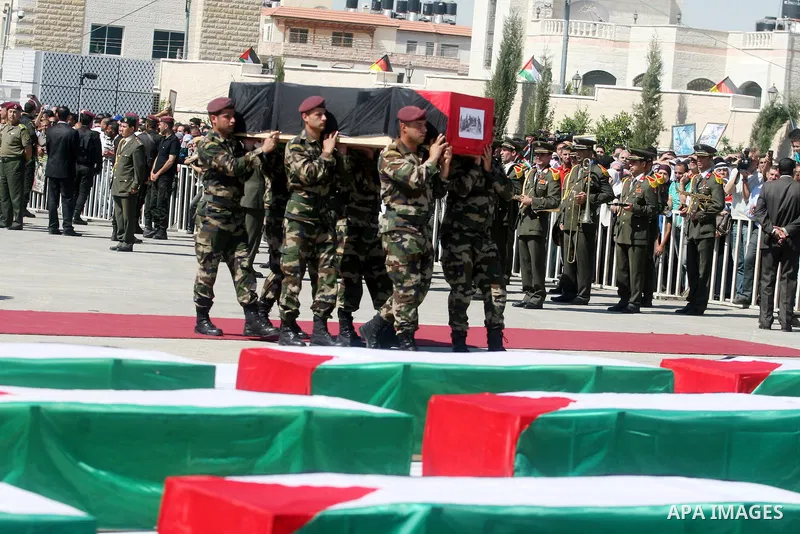 Palestinian Presidential guards carry flag-drapped coffins containing the remains of Palestinian militants during an official ceremony at the President's headquarter in the West Bank town of Ramallah, 31 May 2012. Israel...