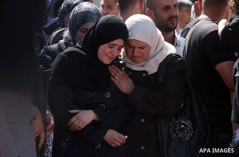 Palestinian women mourn during the funeral of 91 Palestinians whose remains were returned by Israel at the Palestinian headquarters in the West Bank city of Ramallah on May 31, 2012. Israel handed over the remains of sco...