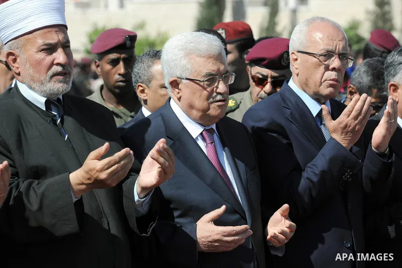 Palestinian President Mahmoud Abbas prays with officials over flag-draped coffins during an official ceremony marking the return of the remains of dozens of Palestinians militants in the West Bank city of Ramallah May 31...