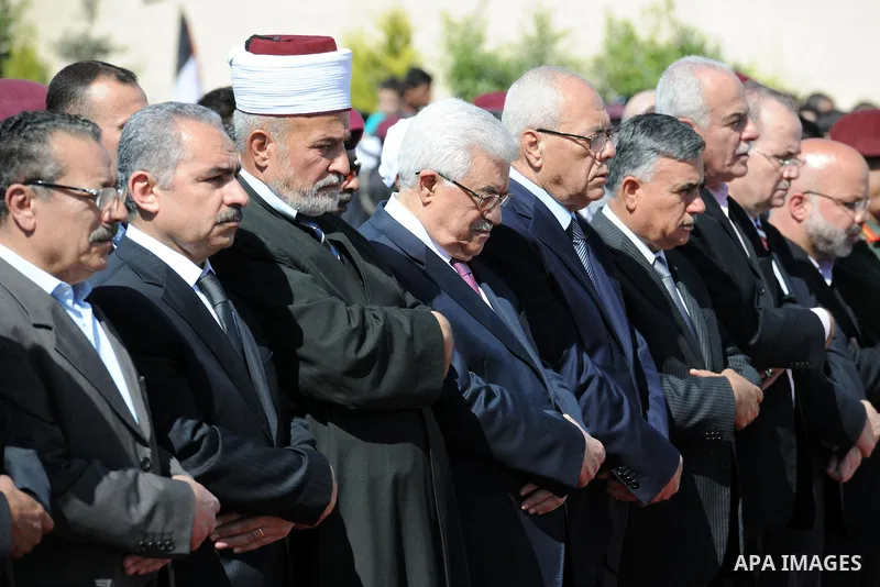 Palestinian President Mahmoud Abbas prays with officials over flag-draped coffins during an official ceremony marking the return of the remains of dozens of Palestinians militants in the West Bank city of Ramallah May 31...