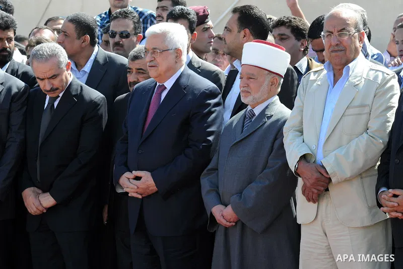 Palestinian President Mahmoud Abbas prays with officials over flag-draped coffins during an official ceremony marking the return of the remains of dozens of Palestinians militants in the West Bank city of Ramallah May 31...