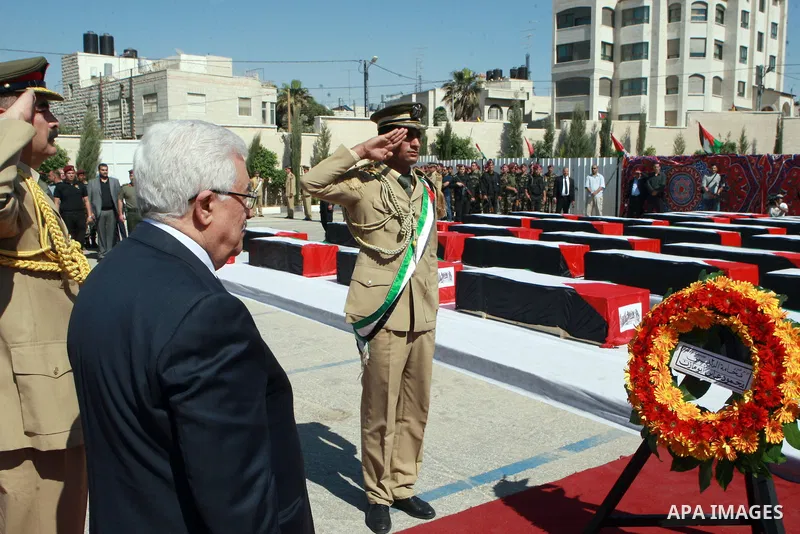 Palestinian President Mahmoud Abbas lays a wreath during an official ceremony marking the return of the remains of dozens of Palestinians militants in the West Bank city of Ramallah May 31, 2012. The remains of 91 Palest...