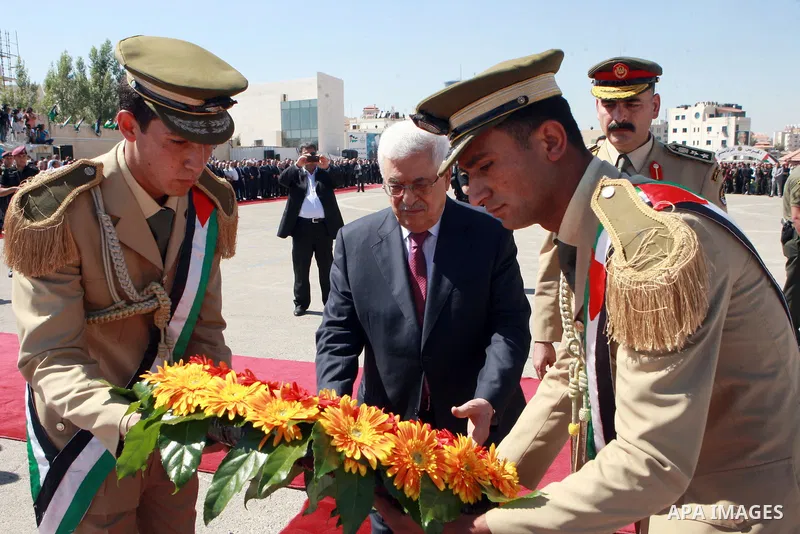 Palestinian President Mahmoud Abbas lays a wreath during an official ceremony marking the return of the remains of dozens of Palestinians militants in the West Bank city of Ramallah May 31, 2012. The remains of 91 Palest...