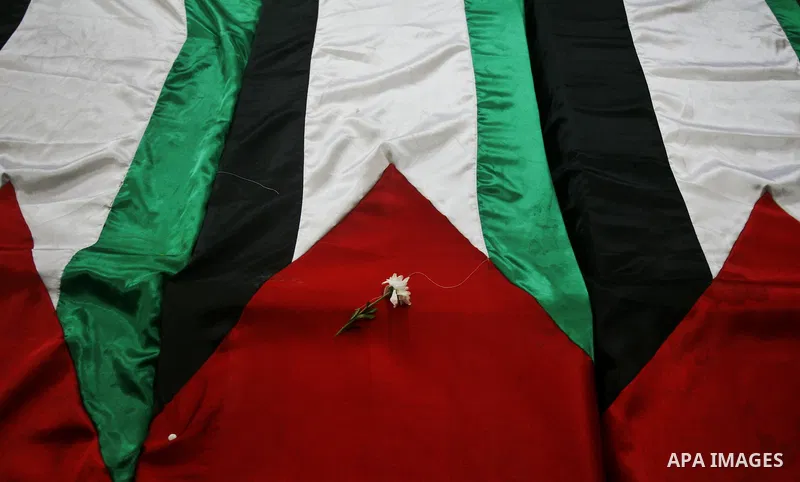 A view of flag-drapped coffins containing the remains of Palestinian militants after the arrival of the caskets in Gaza City, 31 May 2012. Israel handed over the remains of dozens of militants to the Palestinians, saying...