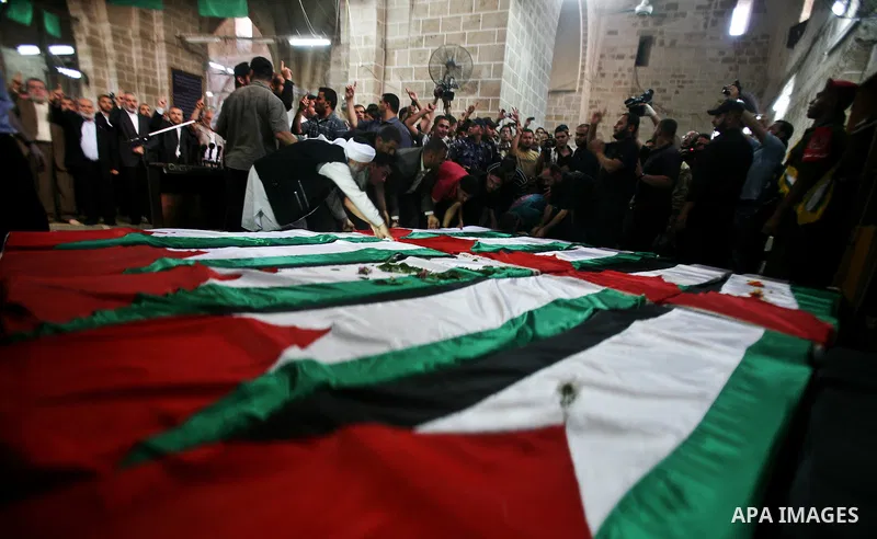 Palestinians pray next to flag-covered coffins containing the remains of Palestinian militants in a mosque in Gaza City May 31, 2012. The remains of 91 Palestinian militants whose attacks killed hundreds of Israelis over...