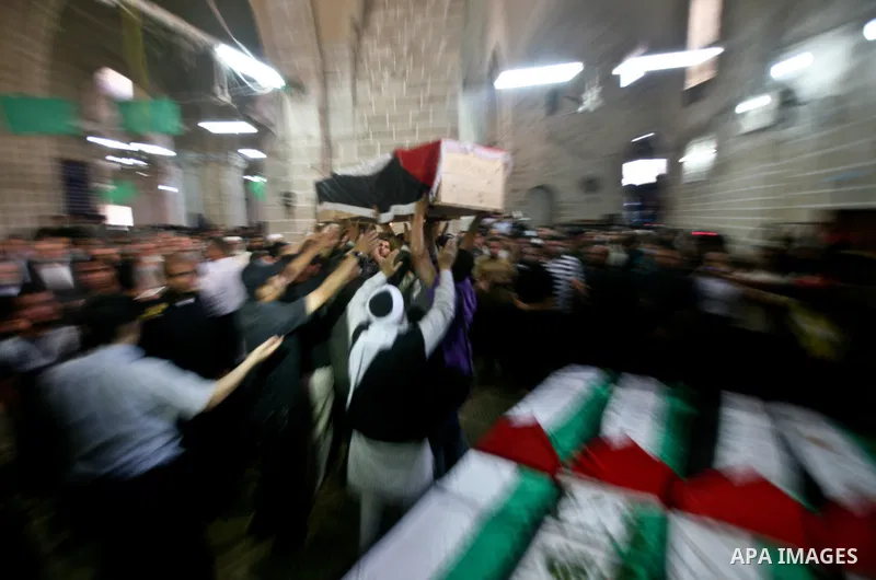 Palestinians pray next to flag-covered coffins containing the remains of Palestinian militants in a mosque in Gaza City May 31, 2012. The remains of 91 Palestinian militants whose attacks killed hundreds of Israelis over...