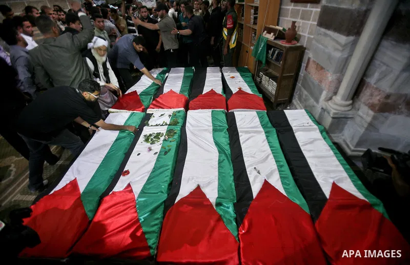 Palestinians pray next to flag-covered coffins containing the remains of Palestinian militants in a mosque in Gaza City May 31, 2012. The remains of 91 Palestinian militants whose attacks killed hundreds of Israelis over...