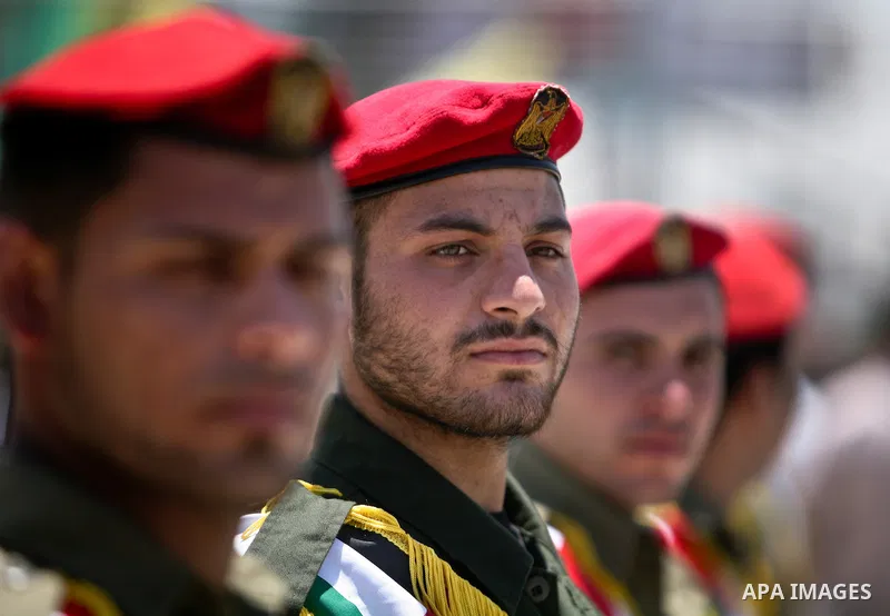 Hamas guard of honour at attention as they wait for the arrival of the remains of 12 Palestinians killed during anti-Israeli attacks, near the Erez crossing in the northern Gaza Strip on May 31, 2012. Israel handed over...