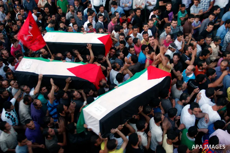 Palestinians carry a flag-drapped coffin in the West Bank town of Nablus, 31 May 2012, with the remains of some of the 90 Palestinian militants Israel handed over to the Palestinian Authority, stating it hoped the 'goodw...