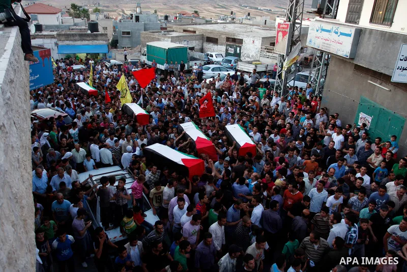 Palestinians carry a flag-drapped coffin in the West Bank town of Nablus, 31 May 2012, with the remains of some of the 90 Palestinian militants Israel handed over to the Palestinian Authority, stating it hoped the 'goodw...
