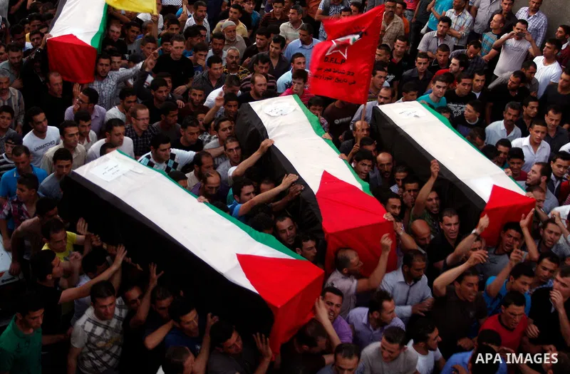 Palestinians carry a flag-drapped coffin in the West Bank town of Nablus, 31 May 2012, with the remains of some of the 90 Palestinian militants Israel handed over to the Palestinian Authority, stating it hoped the 'goodw...