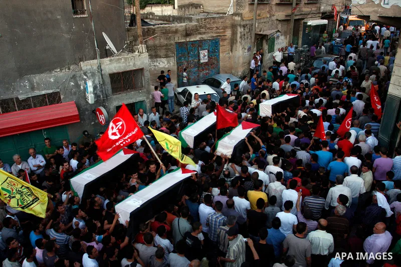 Palestinians carry a flag-drapped coffin in the West Bank town of Nablus, 31 May 2012, with the remains of some of the 90 Palestinian militants Israel handed over to the Palestinian Authority, stating it hoped the 'goodw...