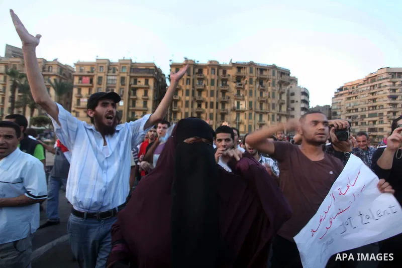 Syrians living in Egypt shout slogans as they protest against the weekend massacre of Houla, in front of the Syrian embassy in Cairo, Egypt, 31 May 2012. A massacre was reported in the central Syrian city of Houla over t...