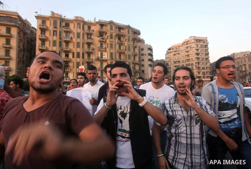 Syrians living in Egypt shout slogans as they protest against the weekend massacre of Houla, in front of the Syrian embassy in Cairo, Egypt, 31 May 2012. A massacre was reported in the central Syrian city of Houla over t...
