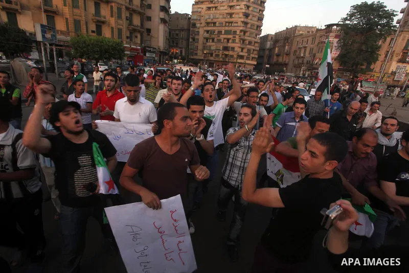 Syrians living in Egypt shout slogans as they protest against the weekend massacre of Houla, in front of the Syrian embassy in Cairo, Egypt, 31 May 2012. A massacre was reported in the central Syrian city of Houla over t...