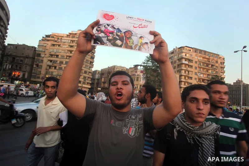 Syrians living in Egypt shout slogans as they protest against the weekend massacre of Houla, in front of the Syrian embassy in Cairo, Egypt, 31 May 2012. A massacre was reported in the central Syrian city of Houla over t...