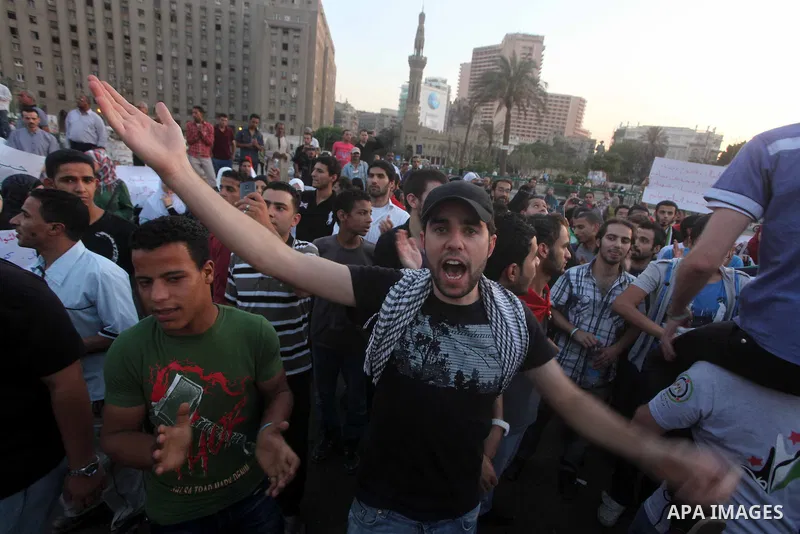 Syrians living in Egypt shout slogans as they protest against the weekend massacre of Houla, in front of the Syrian embassy in Cairo, Egypt, 31 May 2012. A massacre was reported in the central Syrian city of Houla over t...