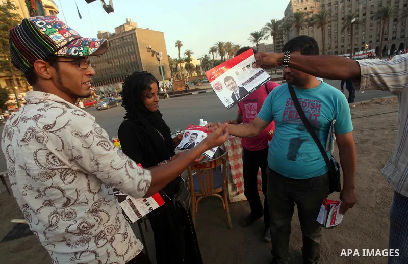 Egyptian Protester holds picture of candidate Mohammed Morsi during a protest against candidate Ahmed Shafiq, at Tahrir Square in Cairo May 31, 2012. The prospect of Shafiq succeeding Hosni Mubarak as president of Egypt...