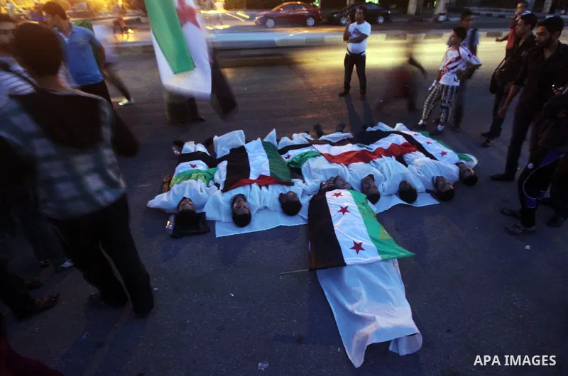 Protesters show solidarity with victims of massacre of Houla during a protest in front of the Syrian embassy in Cairo, Egypt, 31 May 2012. A massacre was reported in the central Syrian city of Houla over the weekend, how...