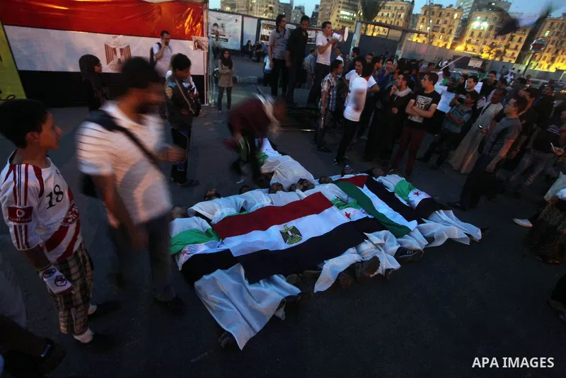 Protesters show solidarity with victims of massacre of Houla during a protest in front of the Syrian embassy in Cairo, Egypt, 31 May 2012. A massacre was reported in the central Syrian city of Houla over the weekend, how...