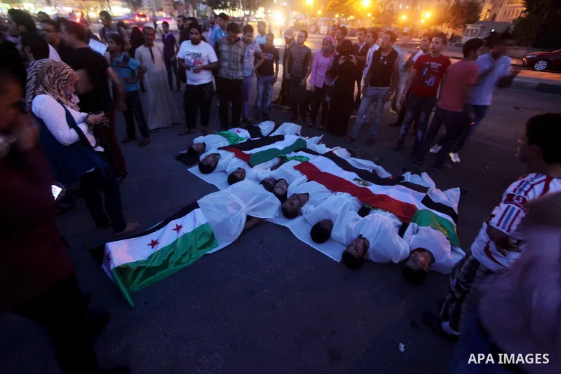 Protesters show solidarity with victims of massacre of Houla during a protest in front of the Syrian embassy in Cairo, Egypt, 31 May 2012. A massacre was reported in the central Syrian city of Houla over the weekend, how...