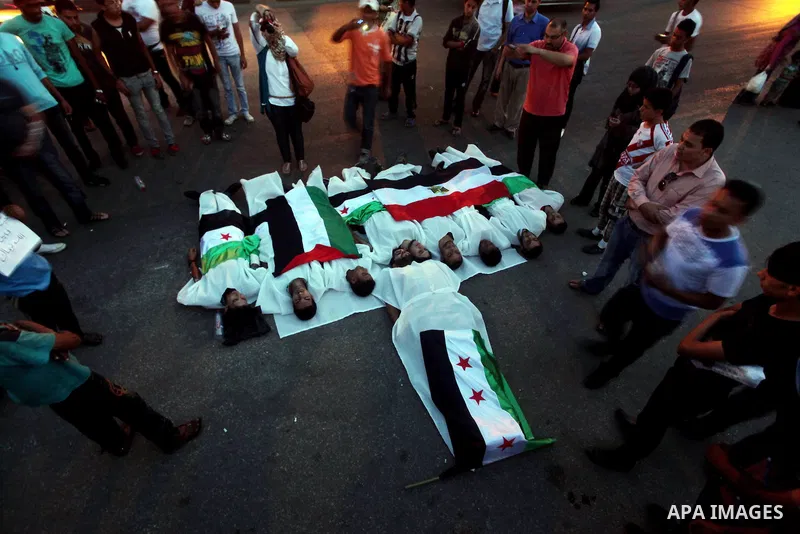 Protesters show solidarity with victims of massacre of Houla during a protest in front of the Syrian embassy in Cairo, Egypt, 31 May 2012. A massacre was reported in the central Syrian city of Houla over the weekend, how...
