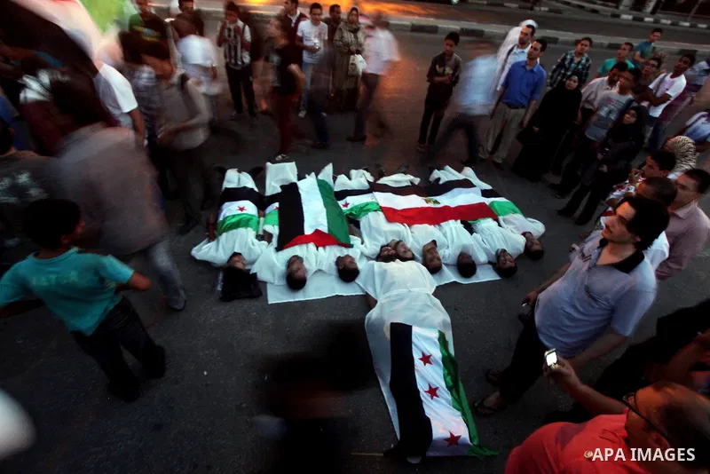 Protesters show solidarity with victims of massacre of Houla during a protest in front of the Syrian embassy in Cairo, Egypt, 31 May 2012. A massacre was reported in the central Syrian city of Houla over the weekend, how...