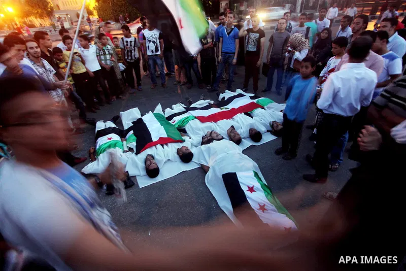 Protesters show solidarity with victims of massacre of Houla during a protest in front of the Syrian embassy in Cairo, Egypt, 31 May 2012. A massacre was reported in the central Syrian city of Houla over the weekend, how...
