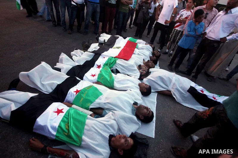 Protesters show solidarity with victims of massacre of Houla during a protest in front of the Syrian embassy in Cairo, Egypt, 31 May 2012. A massacre was reported in the central Syrian city of Houla over the weekend, how...