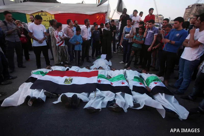 Protesters show solidarity with victims of massacre of Houla during a protest in front of the Syrian embassy in Cairo, Egypt, 31 May 2012. A massacre was reported in the central Syrian city of Houla over the weekend, how...