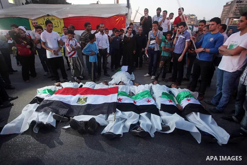 Protesters show solidarity with victims of massacre of Houla during a protest in front of the Syrian embassy in Cairo, Egypt, 31 May 2012. A massacre was reported in the central Syrian city of Houla over the weekend, how...
