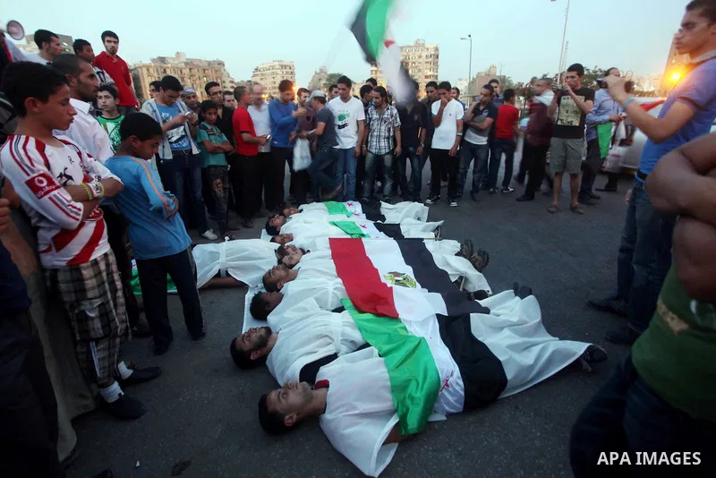 Protesters show solidarity with victims of massacre of Houla during a protest in front of the Syrian embassy in Cairo, Egypt, 31 May 2012. A massacre was reported in the central Syrian city of Houla over the weekend, how...