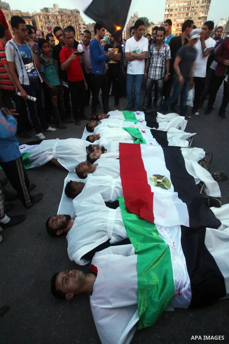 Protesters show solidarity with victims of massacre of Houla during a protest in front of the Syrian embassy in Cairo, Egypt, 31 May 2012. A massacre was reported in the central Syrian city of Houla over the weekend, how...
