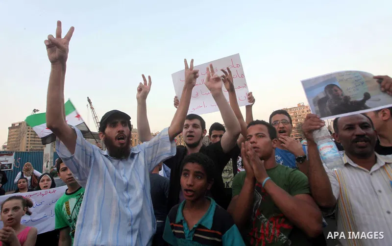 Protesters shout slogans as they protest against the weekend massacre of Houla, in front of the Syrian embassy in Cairo, Egypt, 31 May 2012. A massacre was reported in the central Syrian city of Houla over the weekend, h...