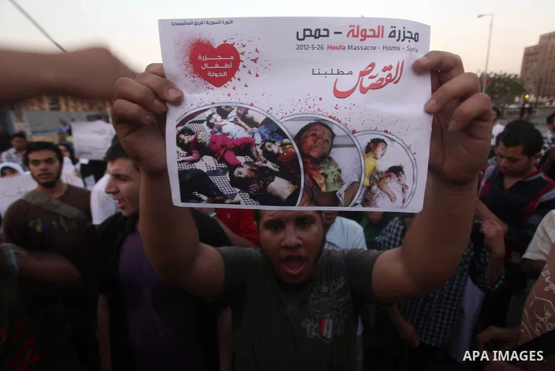 Protesters shout slogans as they protest against the weekend massacre of Houla, in front of the Syrian embassy in Cairo, Egypt, 31 May 2012. A massacre was reported in the central Syrian city of Houla over the weekend, h...