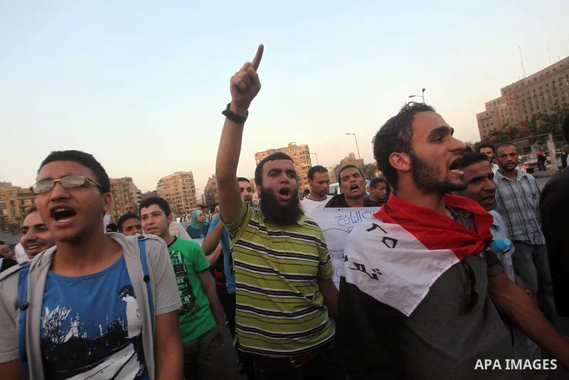 Protesters shout slogans as they protest against the weekend massacre of Houla, in front of the Syrian embassy in Cairo, Egypt, 31 May 2012. A massacre was reported in the central Syrian city of Houla over the weekend, h...