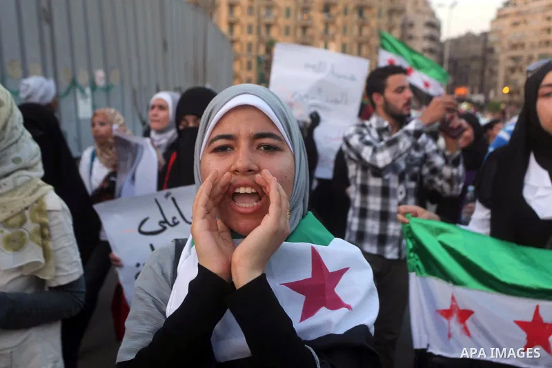 Protesters shout slogans as they protest against the weekend massacre of Houla, in front of the Syrian embassy in Cairo, Egypt, 31 May 2012. A massacre was reported in the central Syrian city of Houla over the weekend, h...