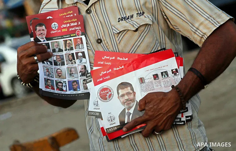 Egyptian Protester holds picture of candidate Mohammed Morsi during a protest against candidate Ahmed Shafiq, at Tahrir Square in Cairo May 31, 2012. The prospect of Shafiq succeeding Hosni Mubarak as president of Egypt...