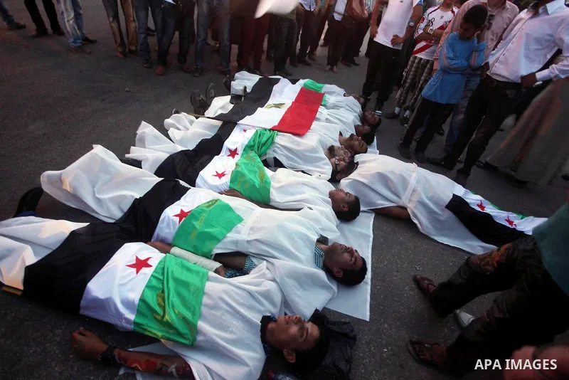 Protesters show solidarity with victims of massacre of Houla during a protest in front of the Syrian embassy in Cairo, Egypt, 31 May 2012. A massacre was reported in the central Syrian city of Houla over the weekend, how...